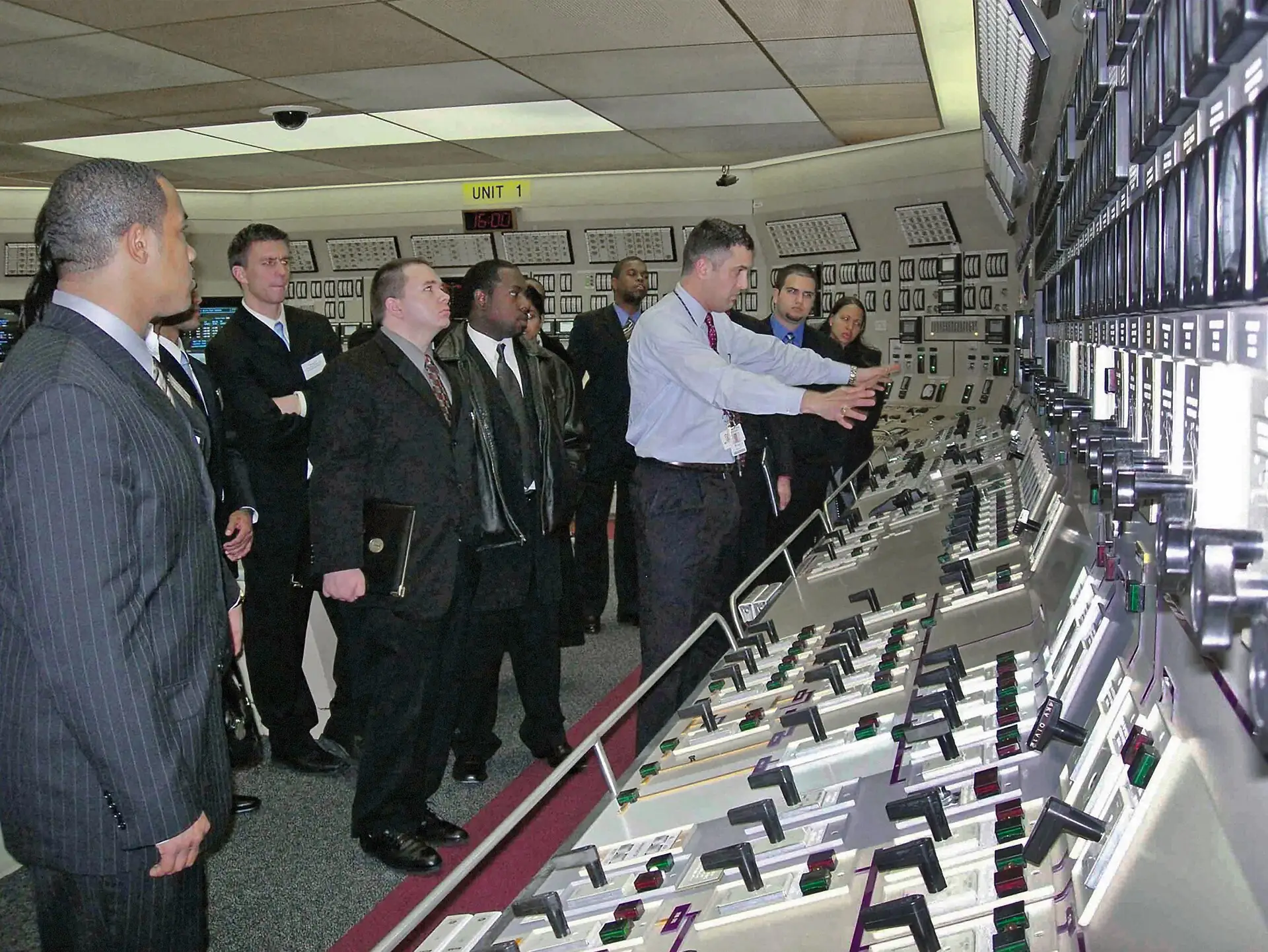 Operators at the main control room desk of a nuclear power plant